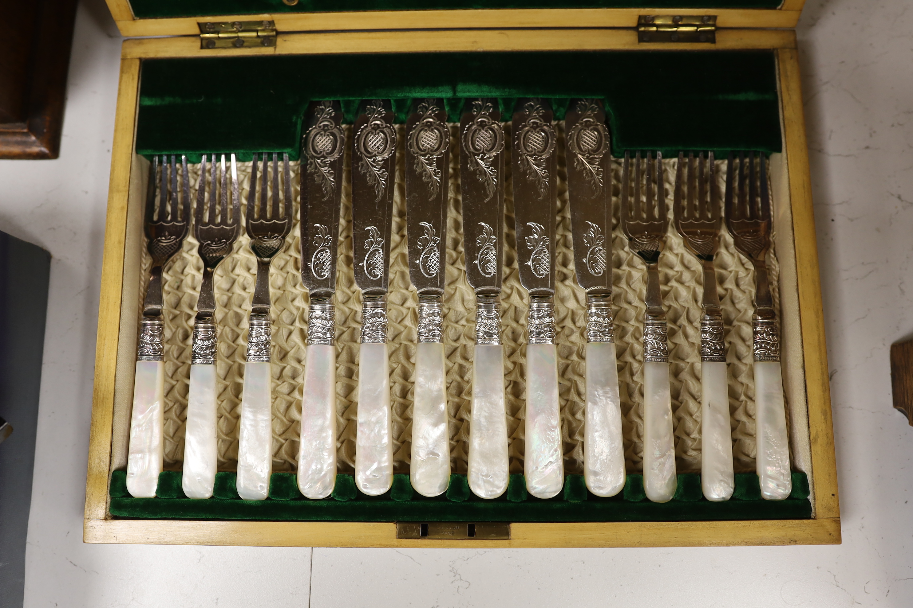 A cased set of twelve mother-of-pearl handled fish knives and forks